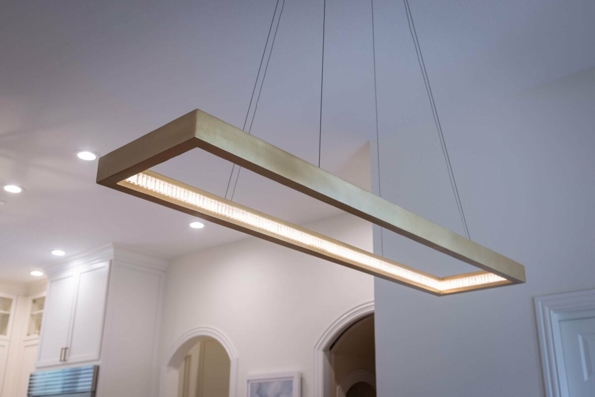 Hanging light eyecandy lighting fixture above family dining table in kitchen remodel by Signature Home Services, Inc.