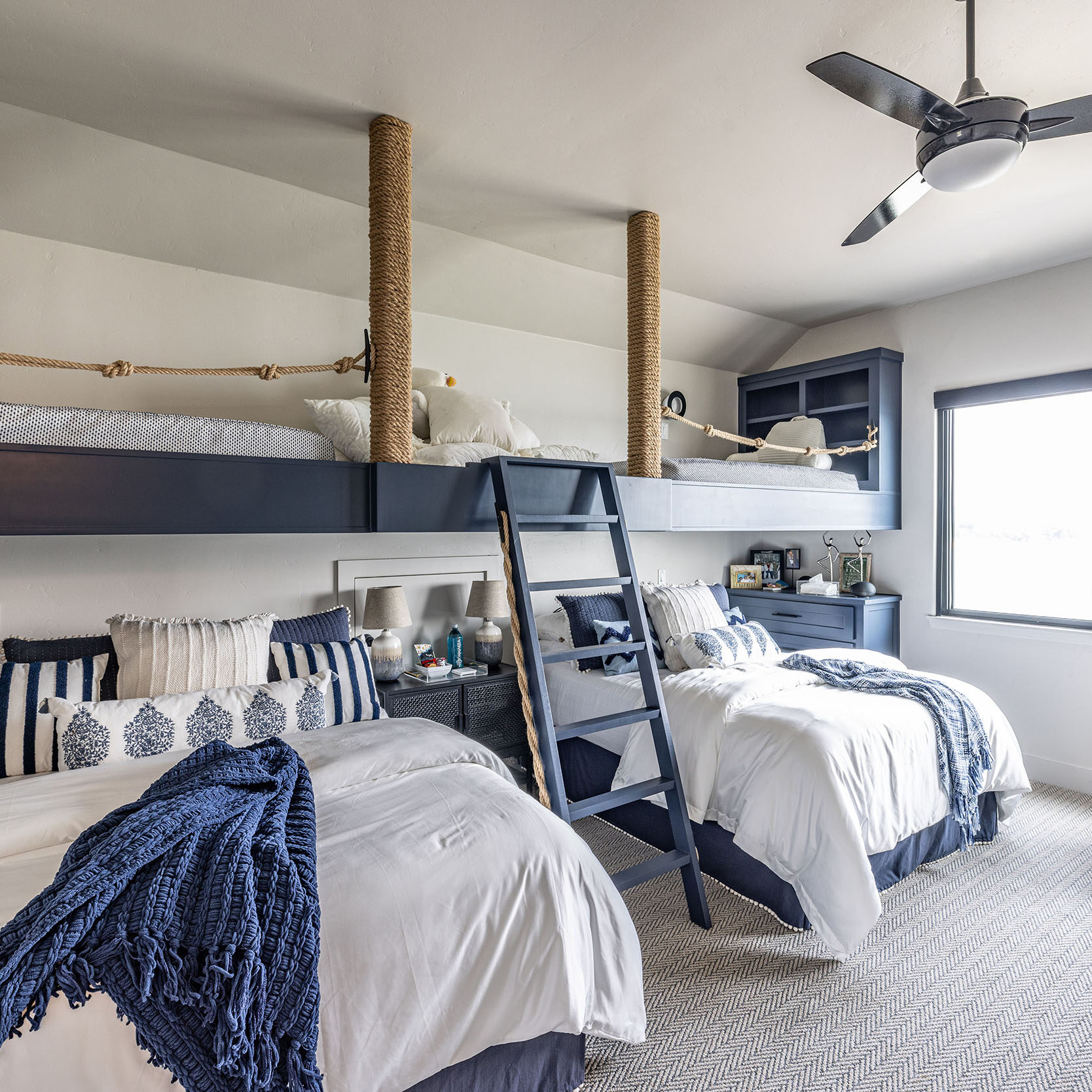 Lake house_Grandkids room with loft bed and overstuffed fluffy bedding and play area in nautical theme second home vacation property in Possum Kingdom Lake Texas